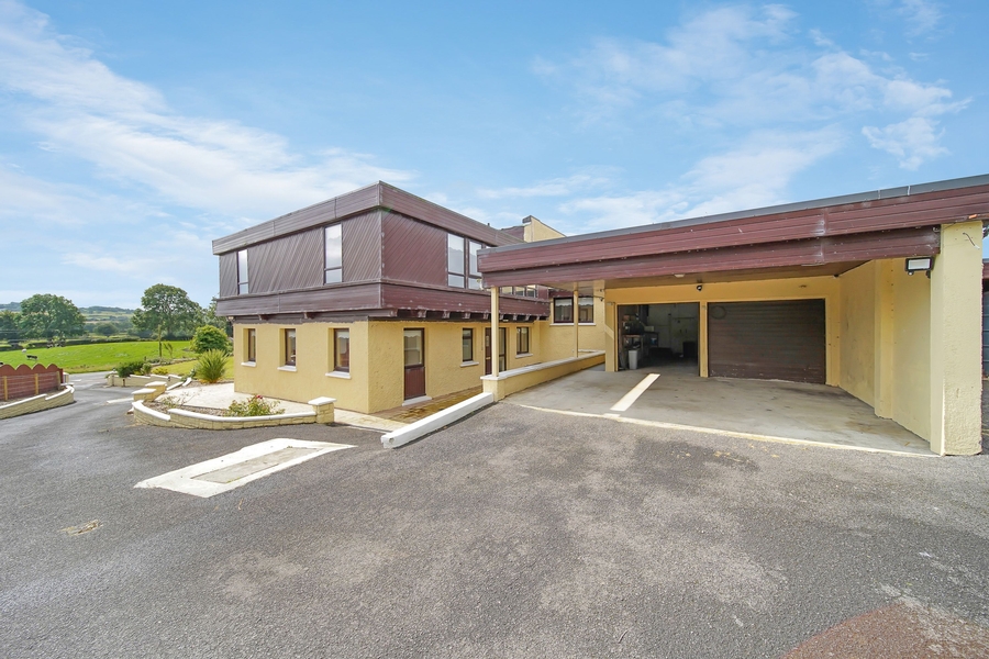 View of side, double garage & parking area.